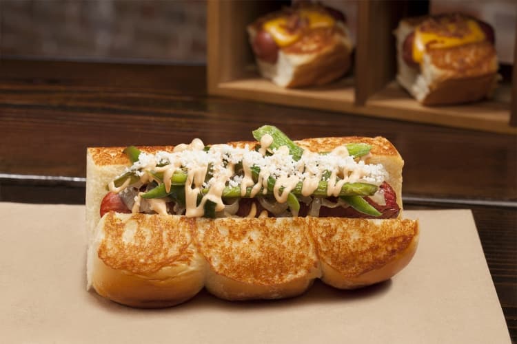 Old Town Dog; smoked bacon wrapped dog, caramelized onions, sautéed jalapeñoschipotle mayo, cotija cheese